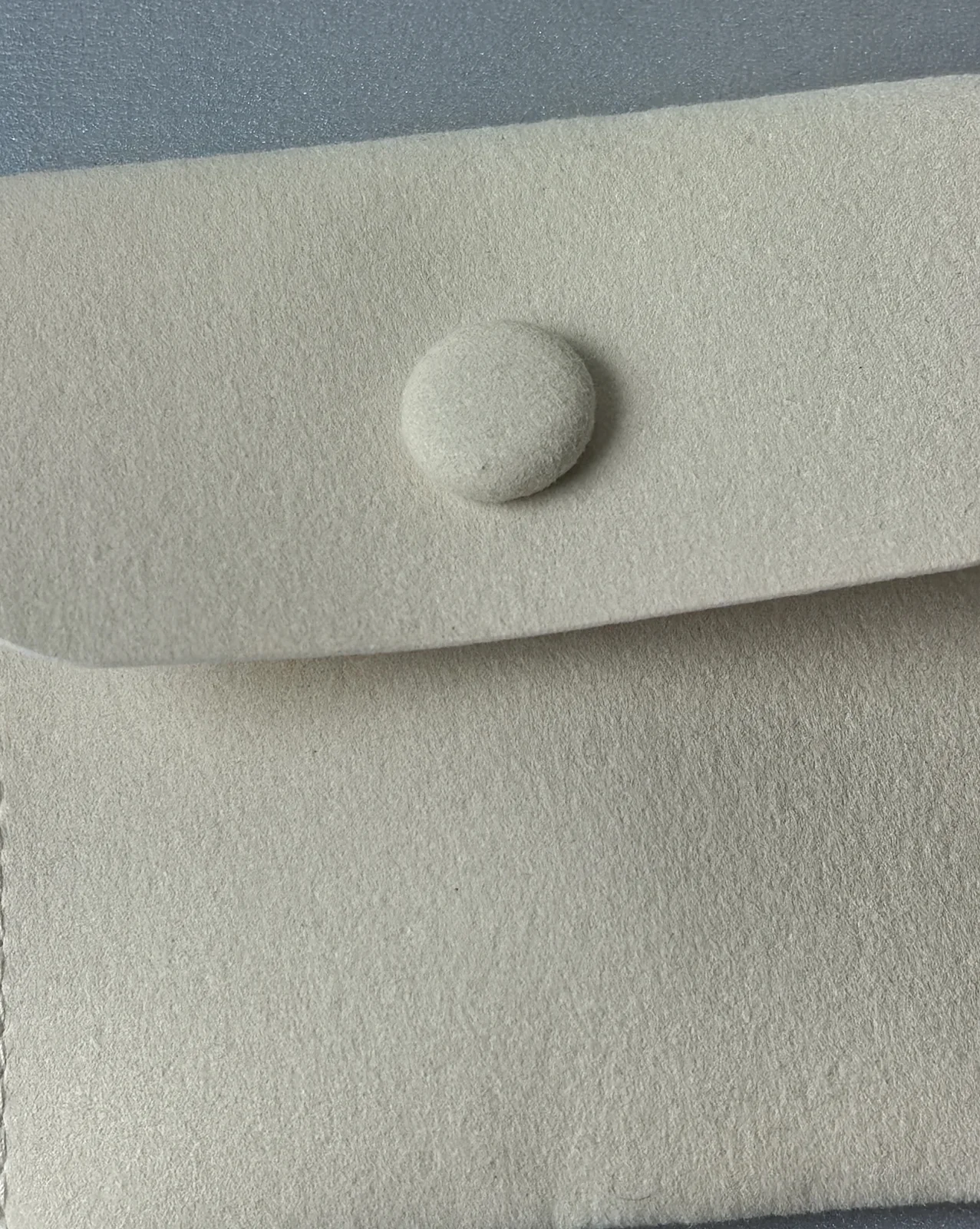 Macro texture of 320 GSM composite microfiber suede and precision stitching