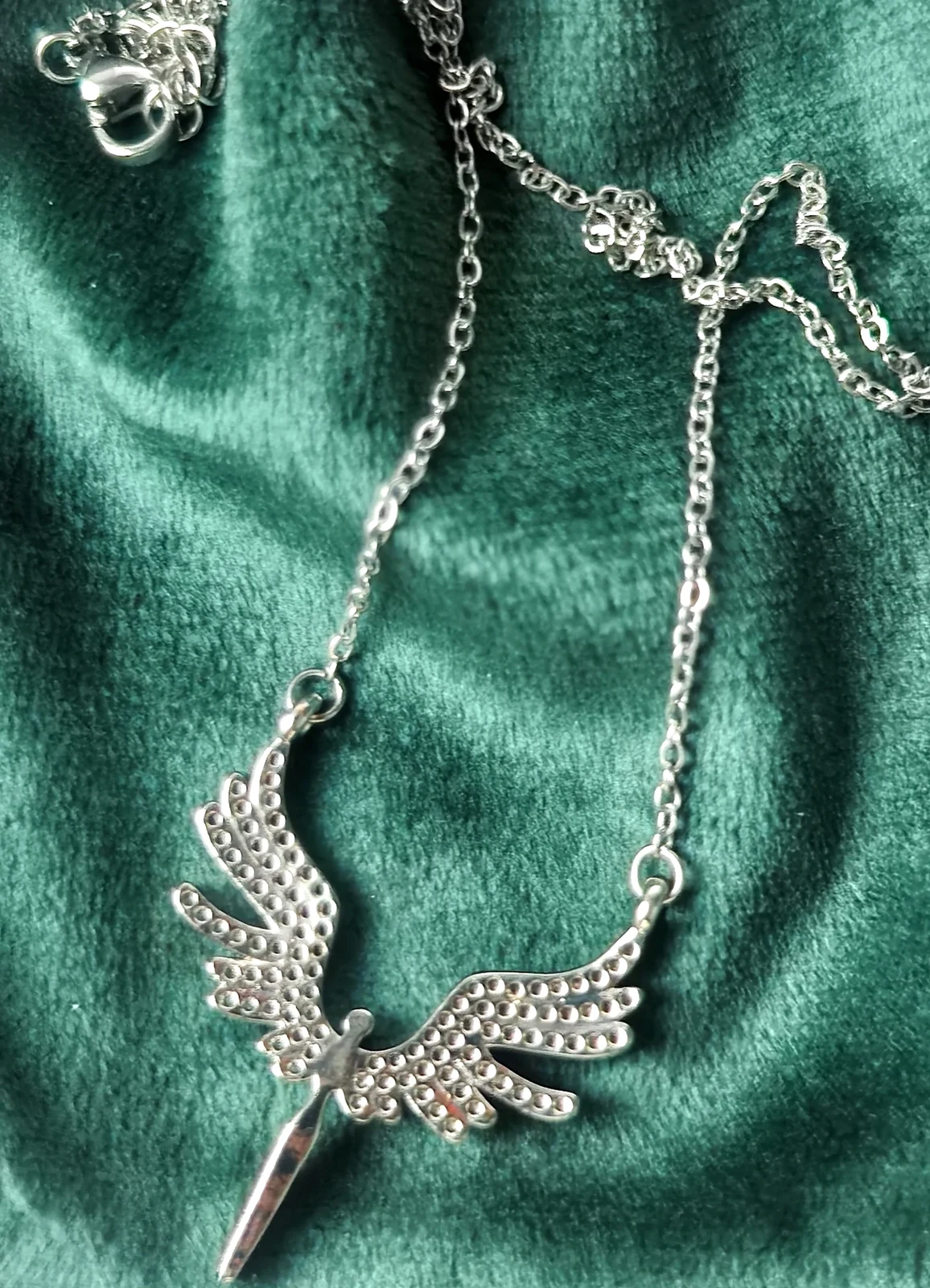 Macro texture of Italian Emerald Green plush velvet and silver necklace